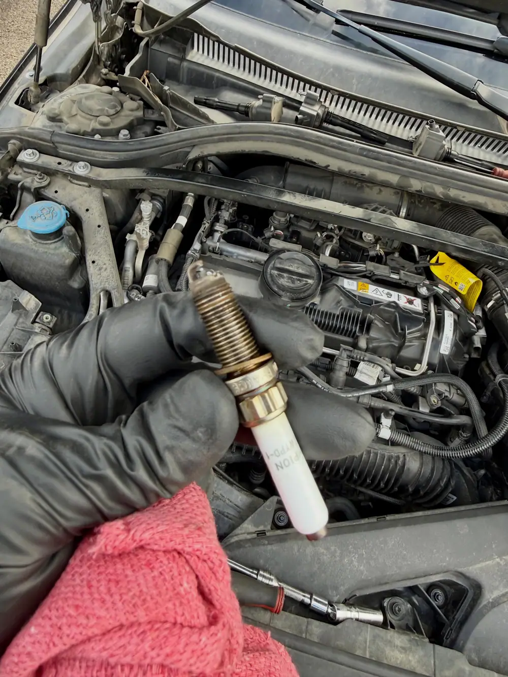 A new spark plug being fitted and torqued to spec on location