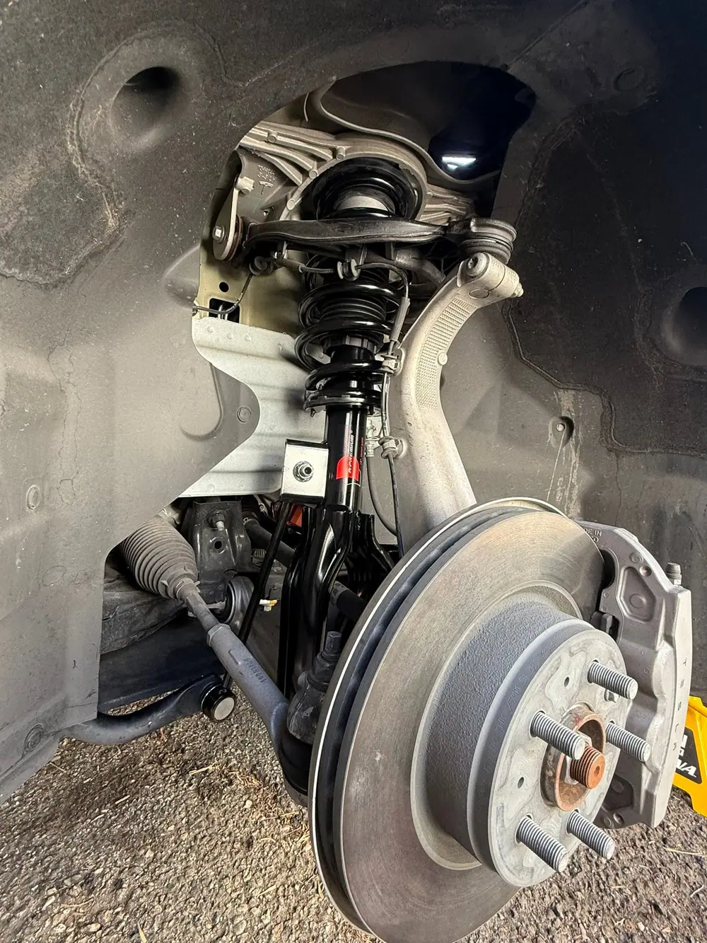 Front suspension and brake disc during a mobile repair