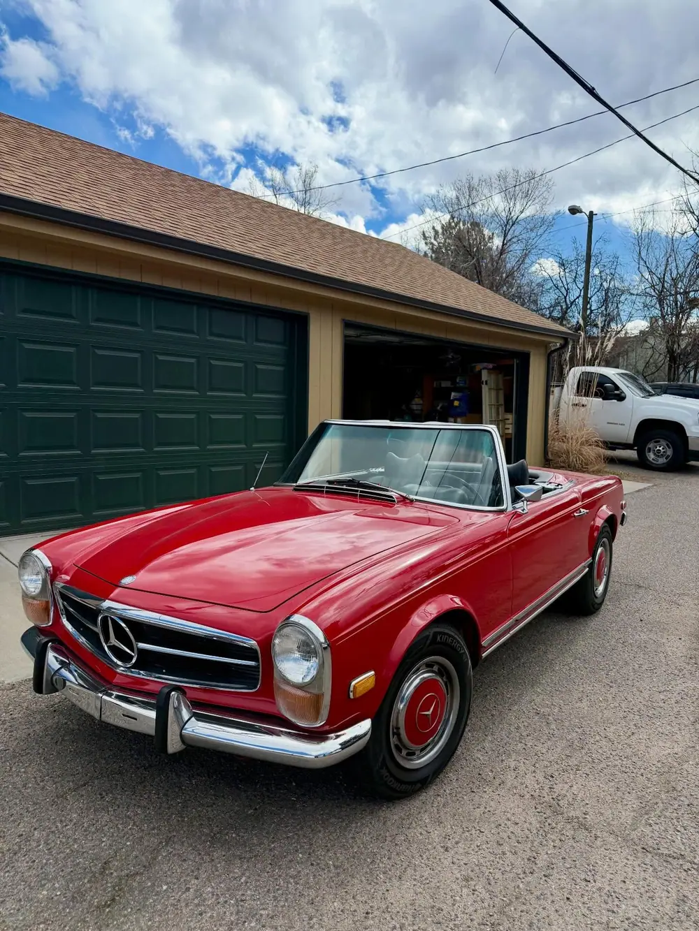 Classic red Mercedes SL serviced on the owner's driveway