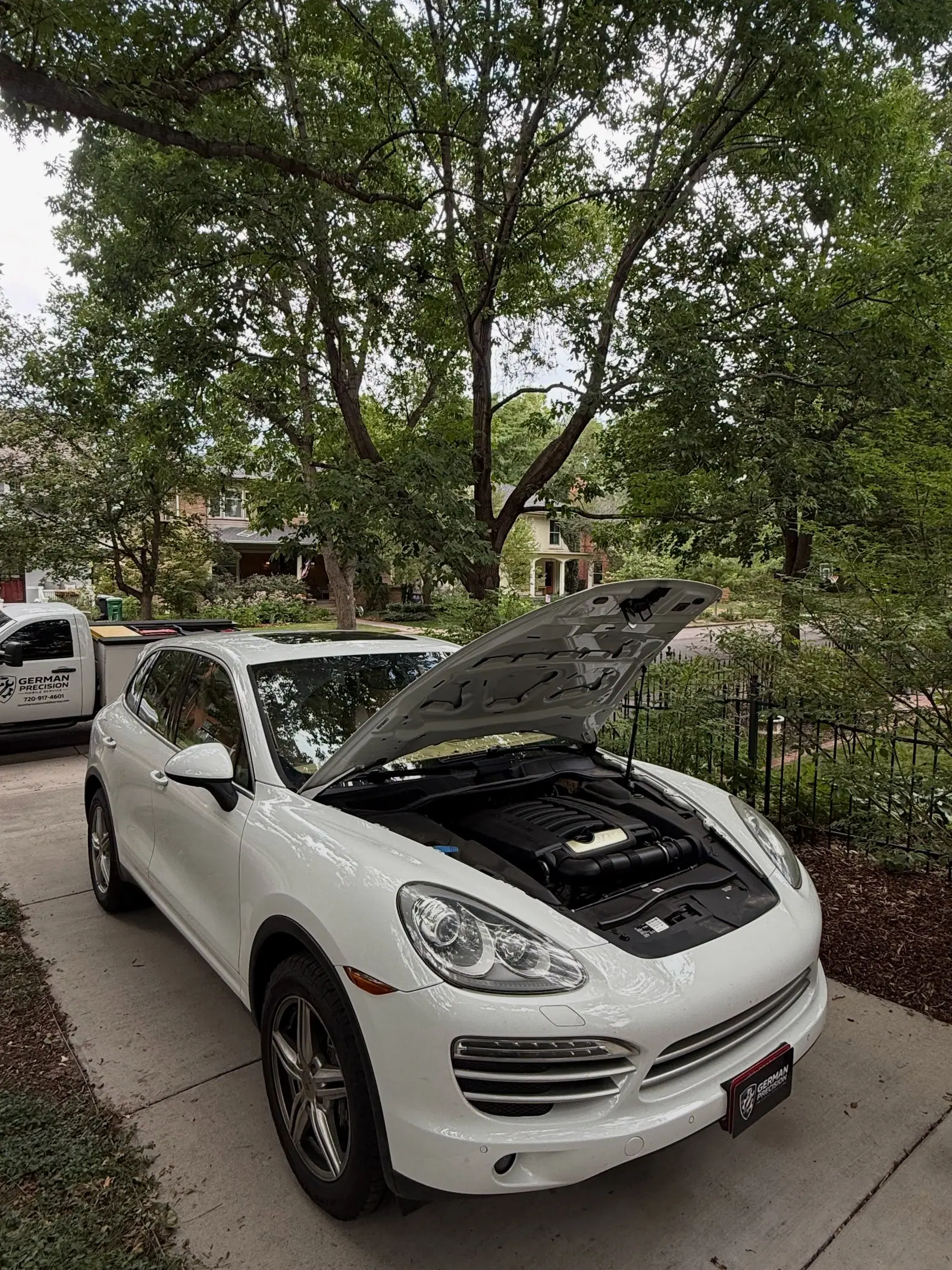 Porsche Cayenne beside the German Precision service truck
