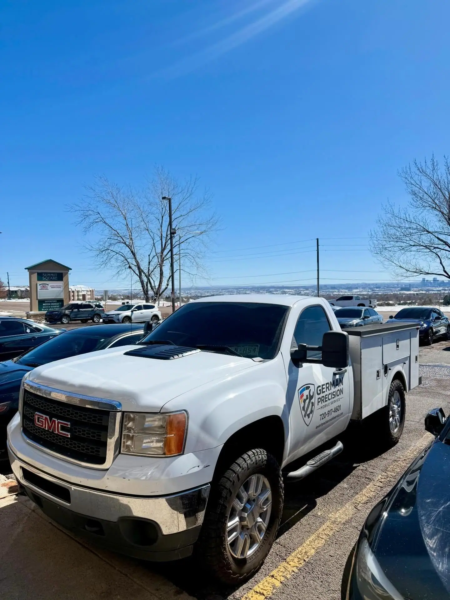 German Precision service truck above the Denver skyline